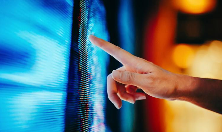 Hand pointing at screen